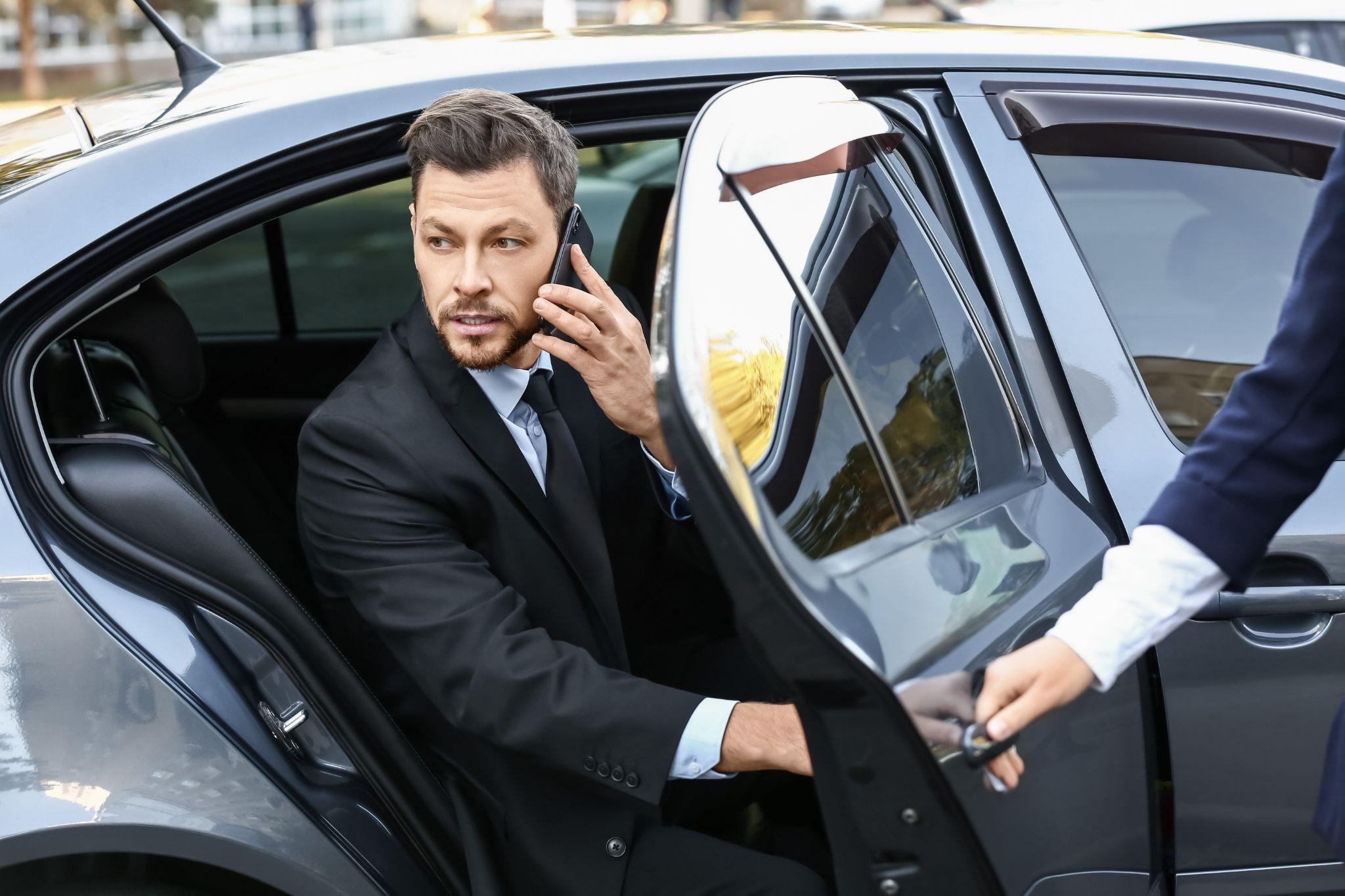 Client relaxing in the back of a luxury vehicle